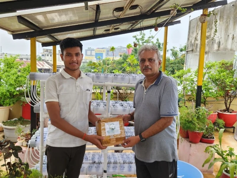 GrowNesso team handing over system package to client on terrace farm setup